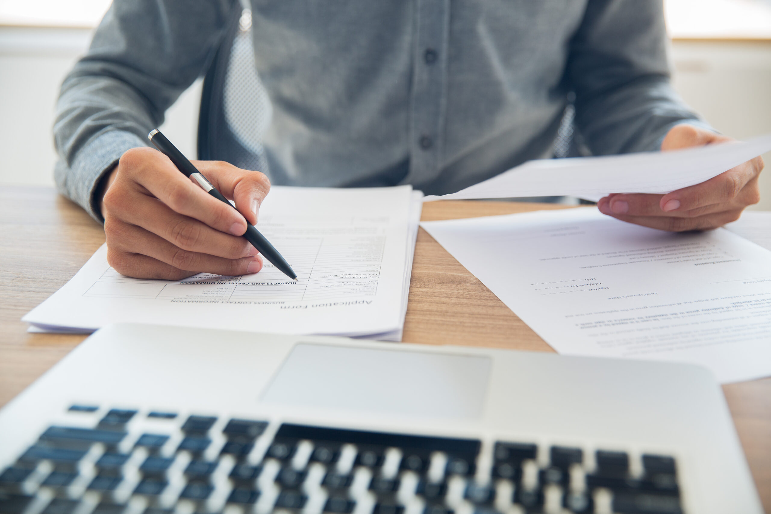 businessman-checking-documents-table-scaled.jpg