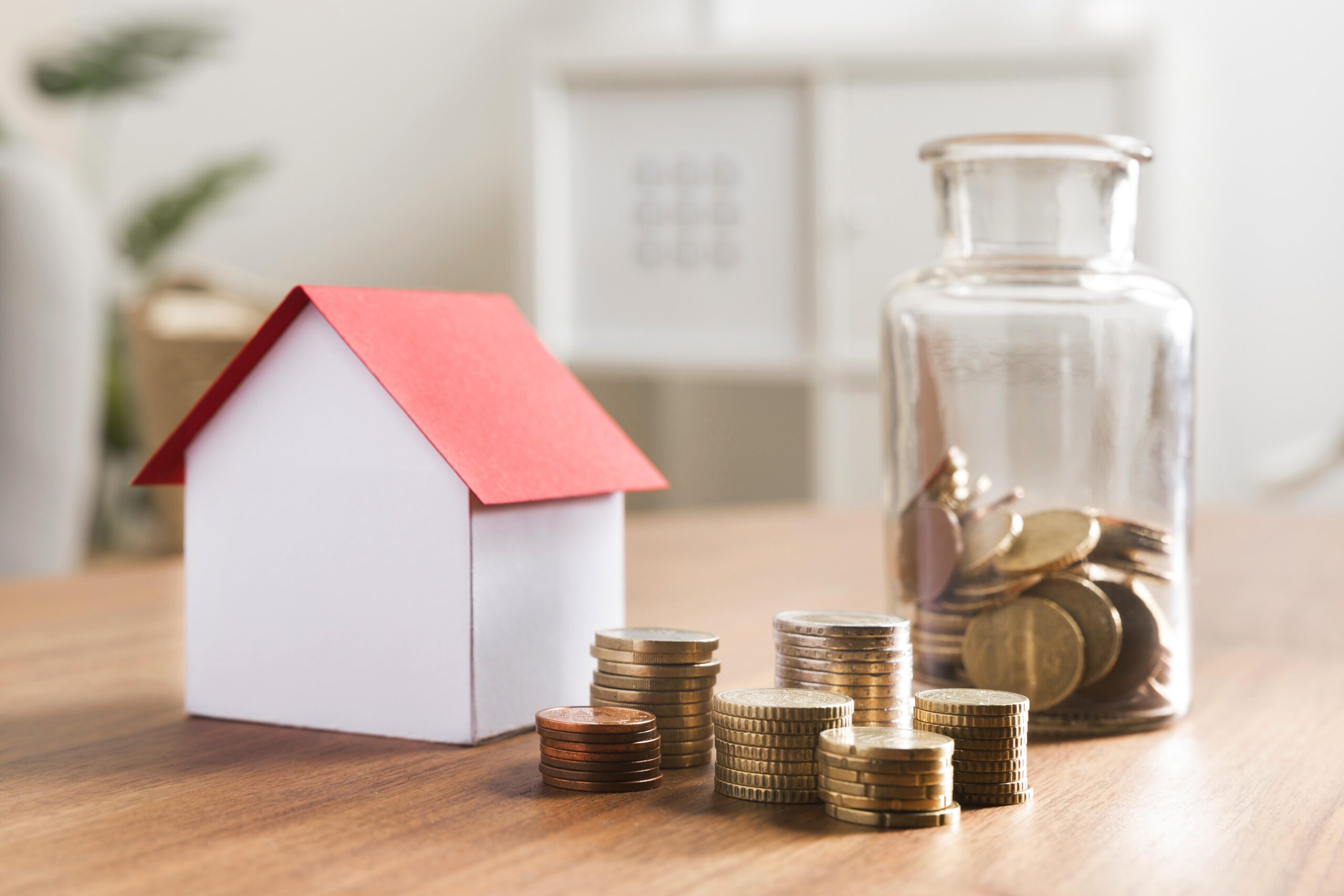 miniature-bank-with-coins-stacks-jar-beside-scaled.jpg